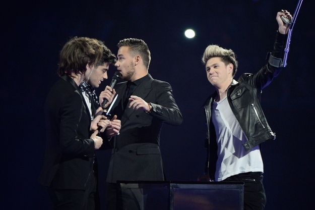 One Direction's Niall Horan celebrates Harry Styles's arrival onstage.