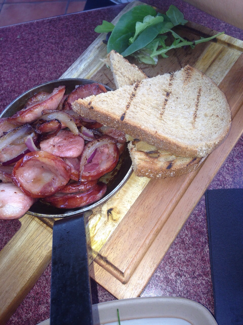 Fresh pork sausages pan fried in Brazilian style with onion and cachaça